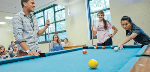 Students playing pool in the dorms